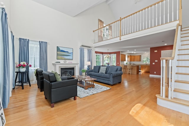17 Tuttle Ln, Wells, ME 04090 - living room with stairway, light wood finished floors, a high ceiling, a tiled fireplace, and recessed lighting