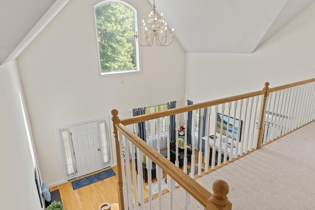 17 Tuttle Ln, Wells, ME 04090 - corridor featuring vaulted ceiling, wood finished floors, a chandelier, and an upstairs landing