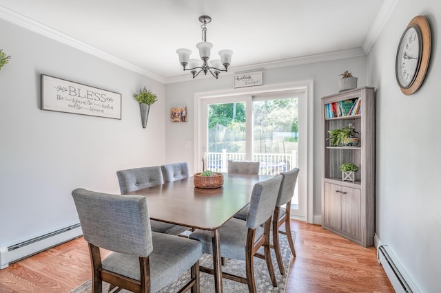 123 Lasalle Dr, Bangor, ME 04401 - dining space featuring a baseboard heating unit, a chandelier, crown molding, and light wood-type flooring