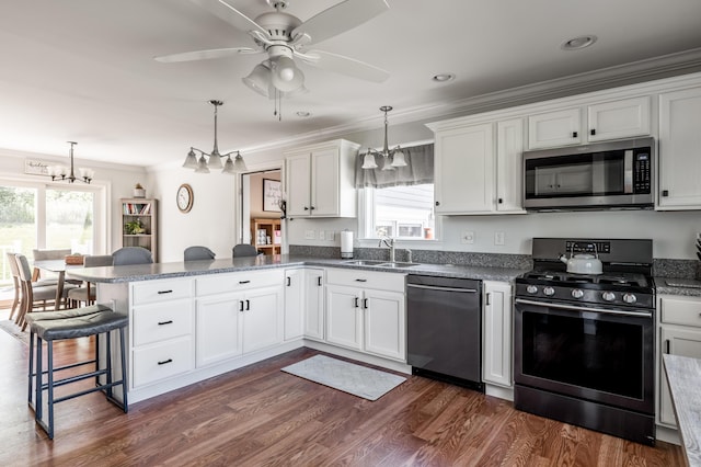 123 Lasalle Dr, Bangor, ME 04401 - kitchen with gas range, dishwashing machine, stainless steel microwave, a peninsula, and crown molding