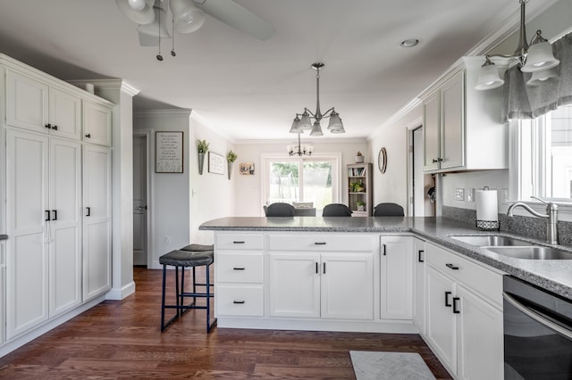 123 Lasalle Dr, Bangor, ME 04401 - kitchen featuring dishwasher, a peninsula, a breakfast bar, a chandelier, and white cabinets