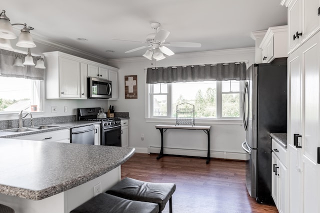 123 Lasalle Dr, Bangor, ME 04401 - kitchen with appliances with stainless steel finishes, healthy amount of natural light, a baseboard radiator, white cabinetry, and crown molding