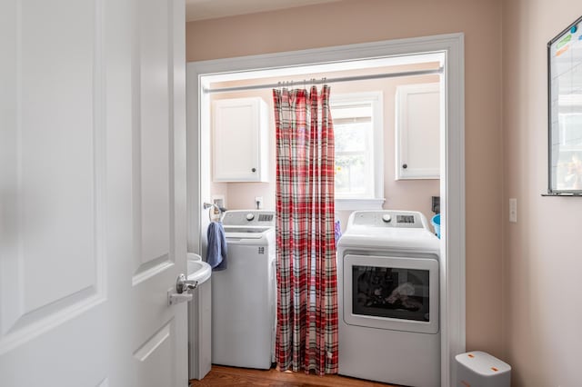 123 Lasalle Dr, Bangor, ME 04401 - laundry room with cabinet space, washer and clothes dryer, and wood finished floors