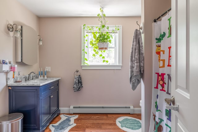 123 Lasalle Dr, Bangor, ME 04401 - full bathroom featuring baseboard heating, vanity, wood finished floors, and curtained shower