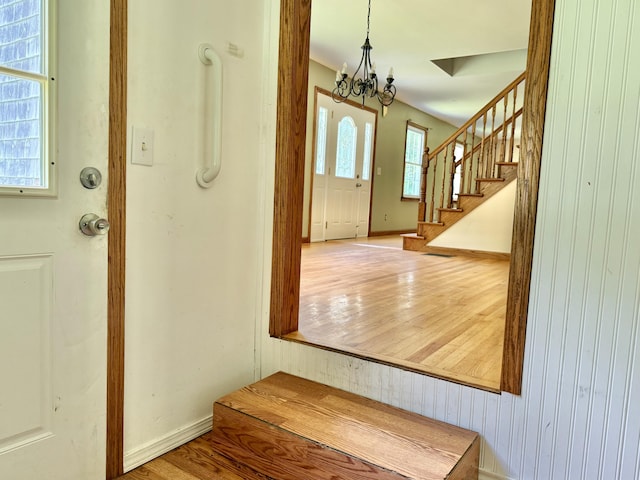 1606 Avenue Rd, Exeter, ME 04435 - foyer featuring a chandelier, stairway, and wood finished floors