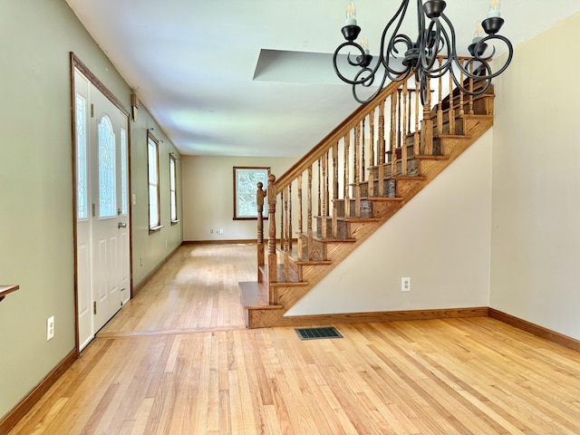 1606 Avenue Rd, Exeter, ME 04435 - foyer entrance featuring a chandelier, wood-type flooring, and stairs