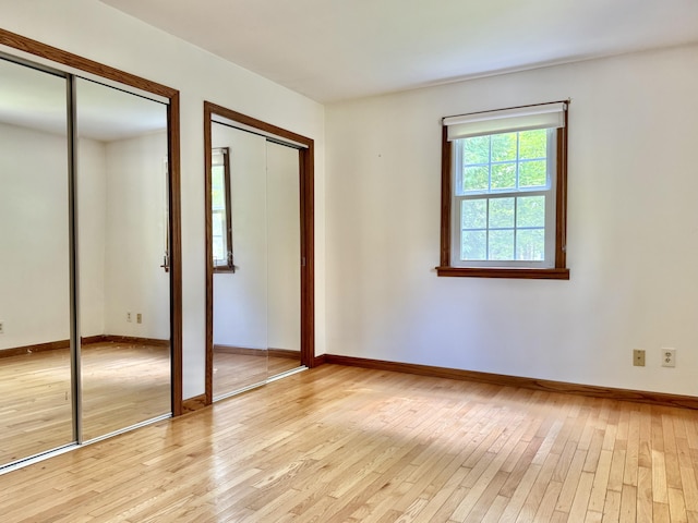 1606 Avenue Rd, Exeter, ME 04435 - unfurnished bedroom featuring two closets and light wood-style flooring