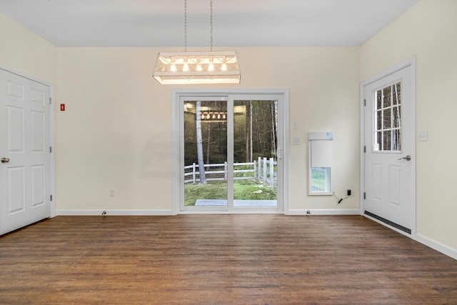 1031 Hallowell Rd, Durham, ME 04222 - unfurnished dining area featuring dark wood-style floors and baseboards