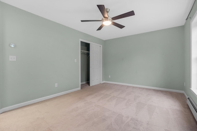 1031 Hallowell Rd, Durham, ME 04222 - unfurnished bedroom with light carpet, a baseboard heating unit, a closet, and ceiling fan