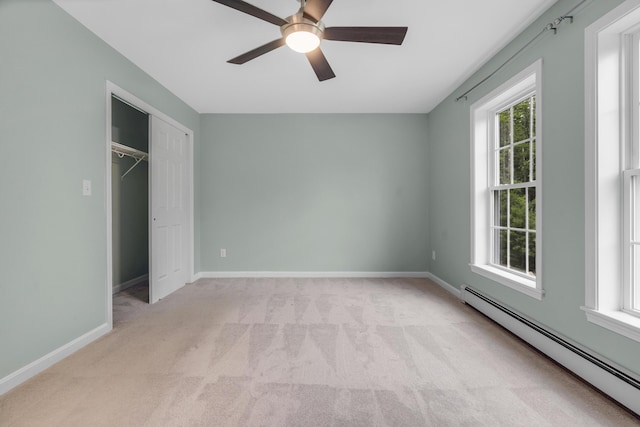 1031 Hallowell Rd, Durham, ME 04222 - unfurnished bedroom with a baseboard radiator, carpet floors, a closet, and ceiling fan