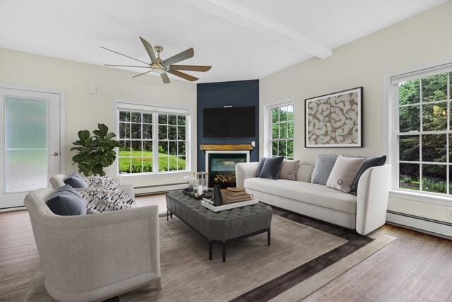 1031 Hallowell Rd, Durham, ME 04222 - living room featuring a baseboard heating unit, ceiling fan, wood finished floors, a baseboard radiator, and a glass covered fireplace