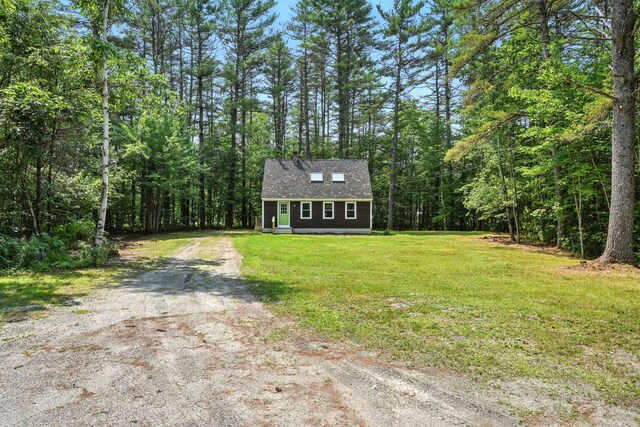 117 Badger Cir, Limerick, ME 04048 - view of front facade featuring driveway, a wooded view, and a front yard