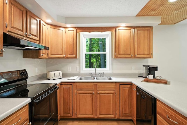 117 Badger Cir, Limerick, ME 04048 - kitchen featuring black appliances, under cabinet range hood, recessed lighting, light countertops, and brown cabinets