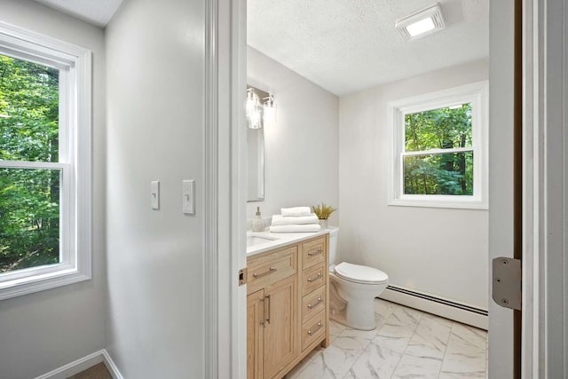 117 Badger Cir, Limerick, ME 04048 - bathroom with a baseboard heating unit, vanity, marble look tile flooring, and a textured ceiling
