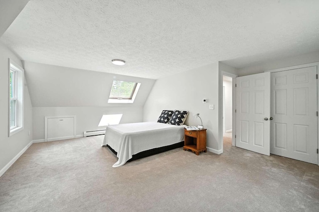 117 Badger Cir, Limerick, ME 04048 - carpeted bedroom with a skylight, baseboard heating, a textured ceiling, and vaulted ceiling