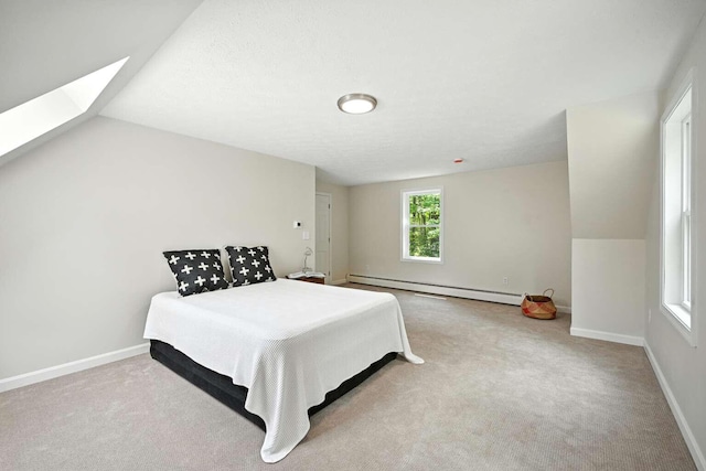 117 Badger Cir, Limerick, ME 04048 - bedroom with a baseboard radiator, carpet floors, a skylight, and vaulted ceiling