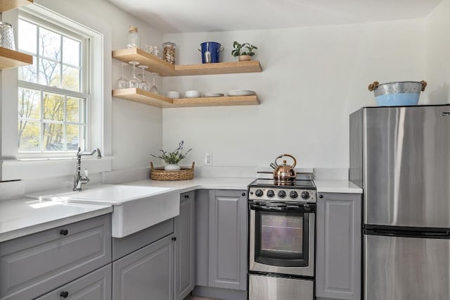 20 Shore Rd Unit 2A, Ogunquit, ME 03907 - kitchen featuring appliances with stainless steel finishes, gray cabinets, open shelves, and light countertops