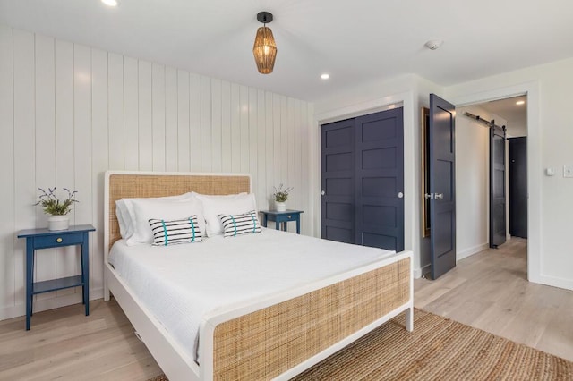20 Shore Rd Unit 2A, Ogunquit, ME 03907 - bedroom with light wood-type flooring, a barn door, recessed lighting, and a closet