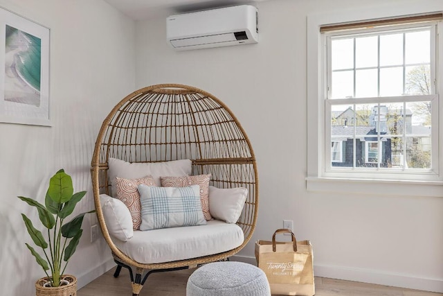 20 Shore Rd Unit 2A, Ogunquit, ME 03907 - living area with a wall mounted air conditioner and wood finished floors