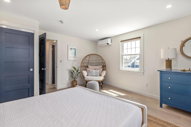 20 Shore Rd Unit 2A, Ogunquit, ME 03907 - bedroom with a wall unit AC, light wood-style flooring, and recessed lighting