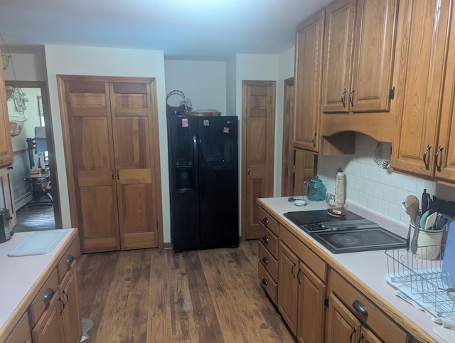 9 Deer Hill Ln, Hampden, ME 04444 - kitchen with black appliances, light countertops, dark wood-style floors, tasteful backsplash, and brown cabinets