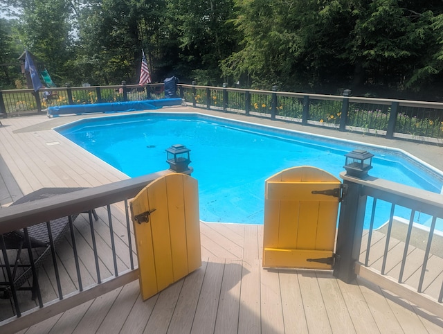 9 Deer Hill Ln, Hampden, ME 04444 - view of pool with a deck and view of wooded area