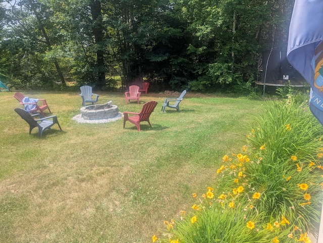 9 Deer Hill Ln, Hampden, ME 04444 - view of green lawn featuring a trampoline and an outdoor fire pit