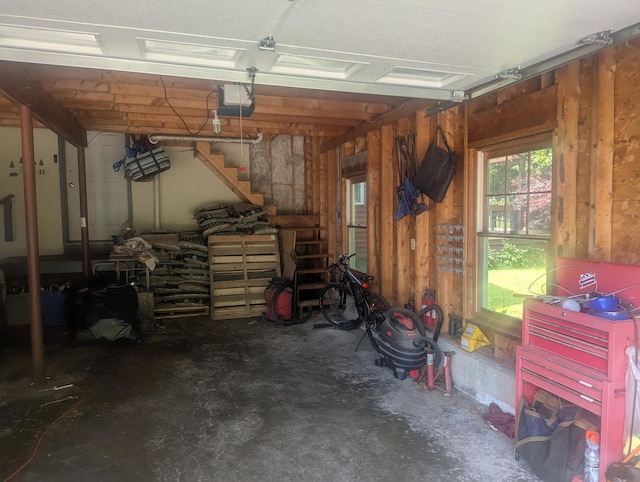 9 Deer Hill Ln, Hampden, ME 04444 - garage with a garage door opener and wooden walls