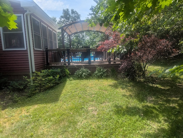9 Deer Hill Ln, Hampden, ME 04444 - view of grassy yard with a wooden deck and an outdoor pool