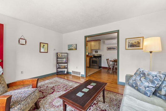 490 Cross Point Rd, Edgecomb, ME 04556 - living area featuring a wall mounted AC and wood finished floors