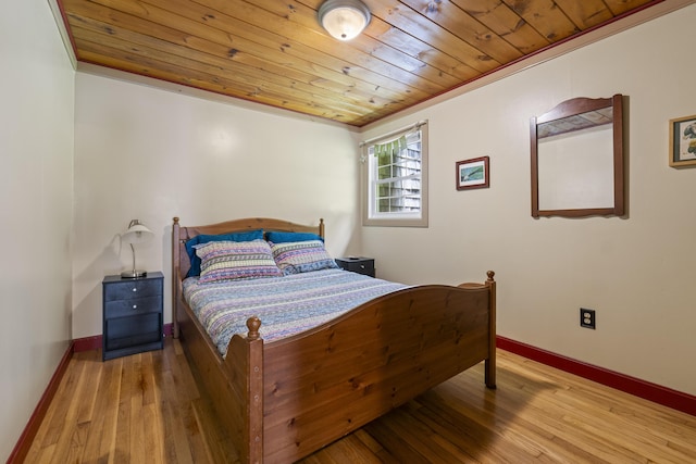 490 Cross Point Rd, Edgecomb, ME 04556 - bedroom with wooden ceiling, ornamental molding, and wood-type flooring