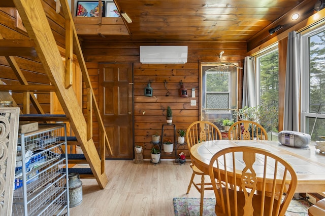 490 Cross Point Rd, Edgecomb, ME 04556 - dining space with wood walls, wooden ceiling, light wood-style floors, and a wall mounted AC