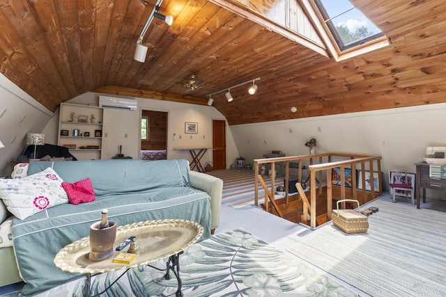 490 Cross Point Rd, Edgecomb, ME 04556 - living area featuring lofted ceiling, wooden ceiling, rail lighting, a skylight, and an AC wall unit