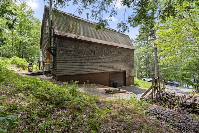 490 Cross Point Rd, Edgecomb, ME 04556 - view of side of property featuring a garage, driveway, and a shingled roof