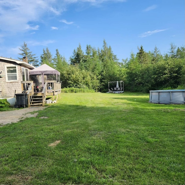 96 N Main St, Milbridge, ME 04658 - view of green lawn featuring a deck, a gazebo, and a covered pool