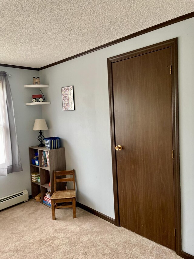 96 N Main St, Milbridge, ME 04658 - living area with a textured ceiling, light carpet, crown molding, and a baseboard radiator
