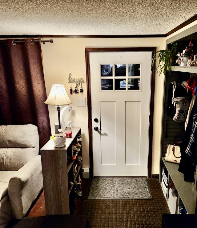 96 N Main St, Milbridge, ME 04658 - entrance foyer with a textured ceiling and dark carpet