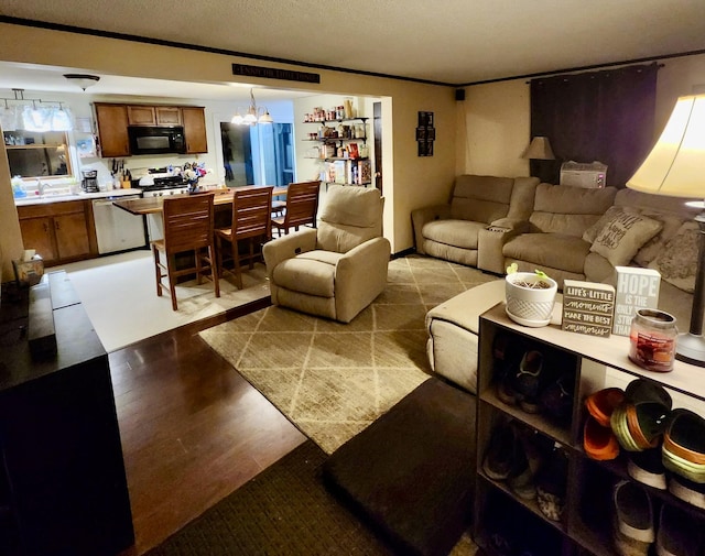 96 N Main St, Milbridge, ME 04658 - living room with a textured ceiling, wood finished floors, and a chandelier