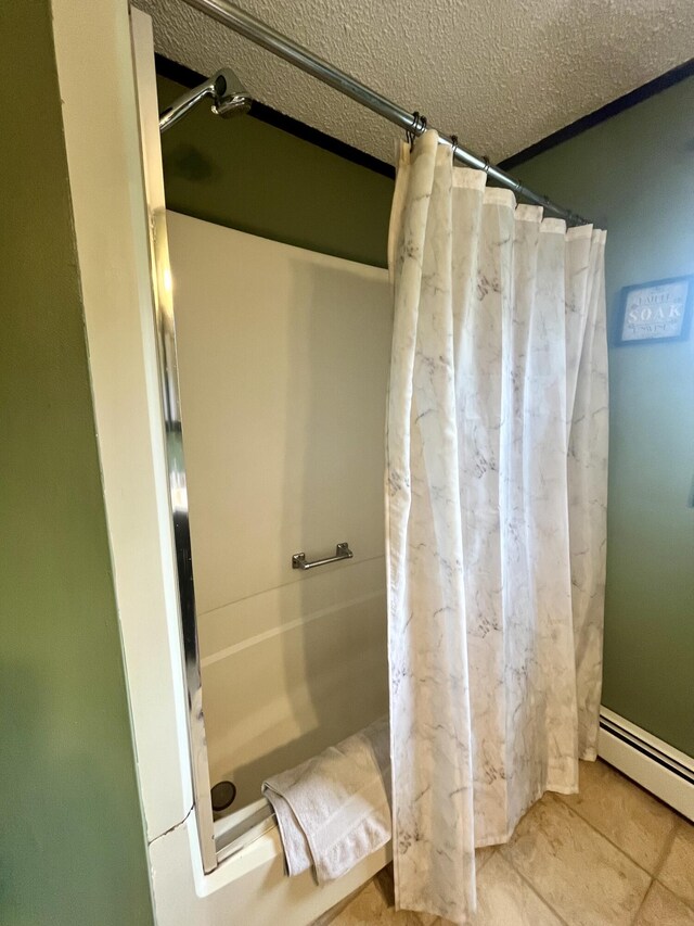 96 N Main St, Milbridge, ME 04658 - bathroom featuring a shower with curtain, a textured ceiling, a baseboard radiator, and tile patterned floors
