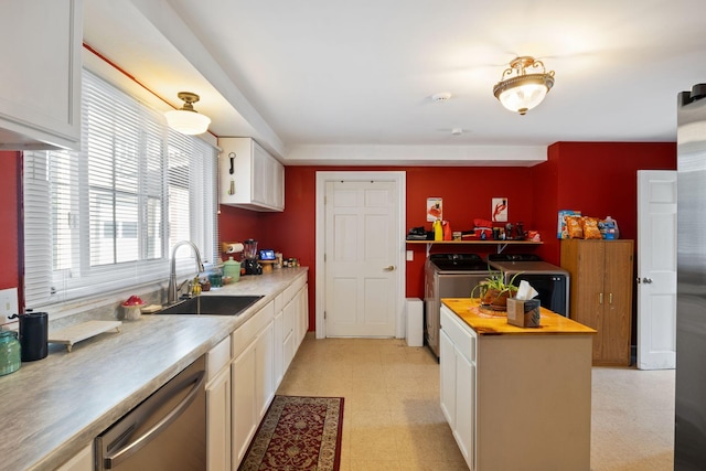 20 Winter St, Augusta, ME 04330 - kitchen with separate washer and dryer, stainless steel dishwasher, light floors, butcher block countertops, and white cabinetry
