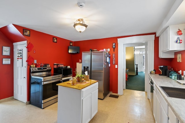 20 Winter St, Augusta, ME 04330 - kitchen with stainless steel appliances, white cabinetry, light floors, and butcher block countertops