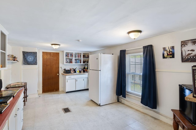 20 Winter St, Augusta, ME 04330 - kitchen featuring freestanding refrigerator, open shelves, white cabinets, and light floors