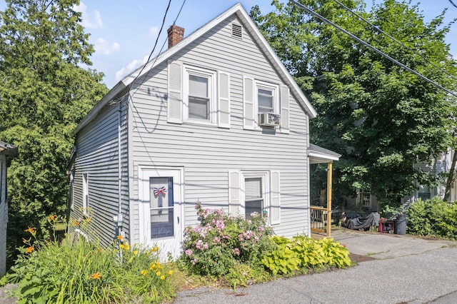 68 Newbury St, Auburn, ME 04210 - view of front of house featuring a chimney and cooling unit