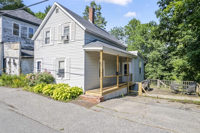 68 Newbury St, Auburn, ME 04210 - bungalow with a chimney, a porch, roof with shingles, cooling unit, and a deck