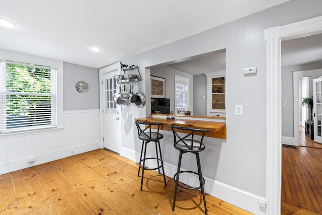 68 Newbury St, Auburn, ME 04210 - kitchen featuring hardwood / wood-style flooring, wainscoting, and recessed lighting