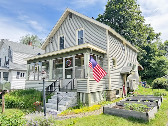 42 Sargent St, Westbrook, ME 04092 - view of front of home with a vegetable garden and a sunroom