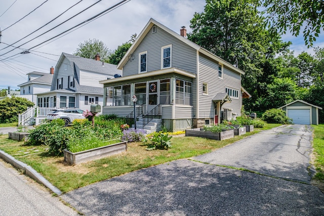 42 Sargent St, Westbrook, ME 04092 - view of front of home with a garden, a sunroom, an outdoor structure, a chimney, and a detached garage