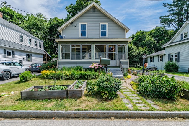 42 Sargent St, Westbrook, ME 04092 - view of front facade with a garden and a sunroom
