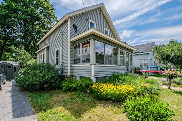 42 Sargent St, Westbrook, ME 04092 - view of side of home featuring a storage shed and a sunroom