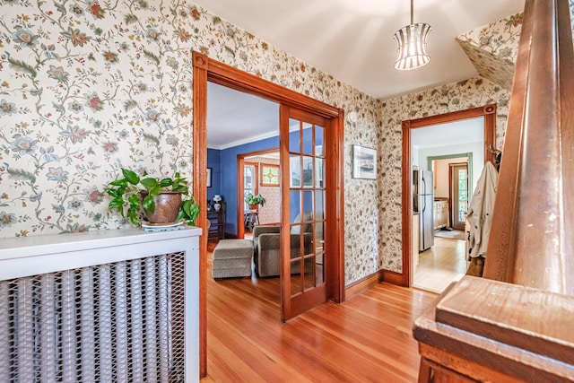 42 Sargent St, Westbrook, ME 04092 - hall with wallpapered walls and light wood finished floors
